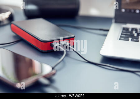 Close up to power bank USB-C ports connected to two devices. Stock Photo