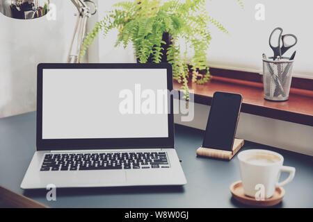Composition of office devices and white laptop screen. Stock Photo