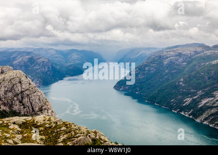 Panoramic mountain view to the long narrow and blue Lysefjord, Prekestolen hiking trail, Forsand, Rogaland county, Norway. Stock Photo
