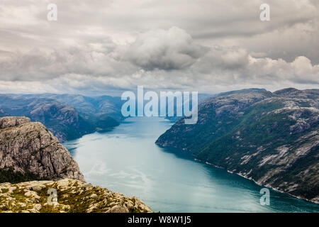 Panoramic mountain view to the long narrow and blue Lysefjord, Prekestolen hiking trail, Forsand, Rogaland county, Norway. Stock Photo