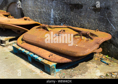 Heavy forged steel trawler doors being stored between uses on the quayside at Ardglass harbour. These doors are a vital part of trawler fishing gear Stock Photo