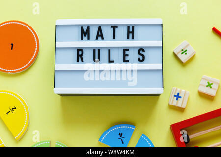 Creative Сolorful blocks, light box, fractions on yellow background. Interesting funny math for kids. Education, back to school concept. Geometry and