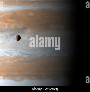 A New Year for Jupiter and Io -  The Galilean satellite Io floats above the cloudtops of Jupiter in this image captured on the dawn of the new millennium, January 1, 2001 10:00 UTC (spacecraft time), two days after Cassini's closest approach. The image is deceiving: there are 350,000 kilometers - roughly 2.5 Jupiters - between Io and Jupiter's clouds. Io is the size of our Moon, and Jupiter is very big. Stock Photo
