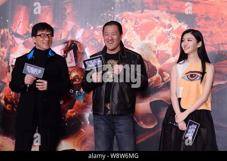 (From left) Hong Kong actor Jackie Chan, Chinese director Ding Sheng and actress Jing Tian smile during a press conference for their movie, Police Sto Stock Photo