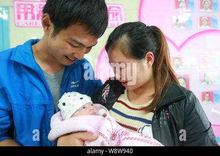 Peng Ankang, a baby whose weight was 0.8kg when he was born on June 17, is held by his mother at the Louxing People's Hospital in Loudi city, central Stock Photo
