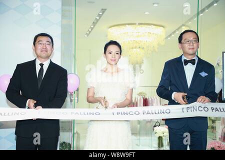Chinese actress Zhang Ziyi, center, cuts the ribbon with executives during the opening ceremony for the new store of Italian luxury children's wear br