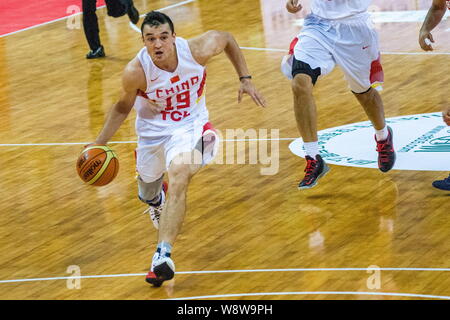 Shirelijan Muxtar of Chinese men's national basketball team, front, competes in the China-Jordan friendly match against Jordan in Shenzhen city, south Stock Photo