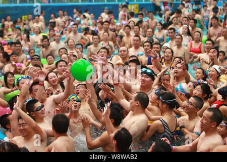 --FILE--Holidaymakers crowd a swimming pool to cool down in an indoor water park at the National Aquatics Center, also known as the Water Cube, in Bei Stock Photo