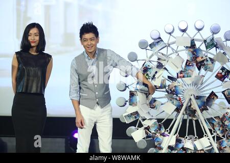 Taiwanese singer and actor Jimmy Lin, right, and Chinese actress Tian Yuan pose during a premiere for his micro film, Discover Love from the Heart, in Stock Photo