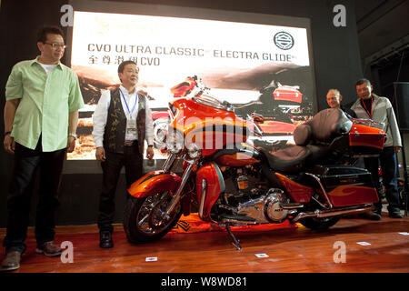 --FILE--Visitors look at a Harley-Davidson CVO Ultra Classic Electra Glide motorcycle during an exhibition in Chongqing, China, 12 October 2012.   US Stock Photo