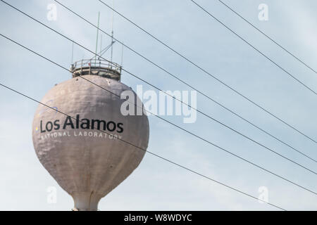 Los Alamos, USA - June 17, 2019: City in New Mexico with view of water tower tank on road with sign for National Laboratory Stock Photo