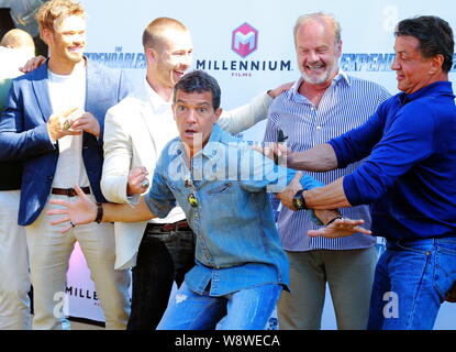 American actor and director Sylvester Stallone, right, Spanish actor Antonio Banderas, front center, and other cast members pose at a photocall for th Stock Photo