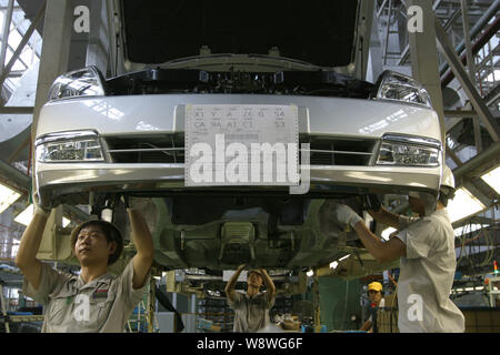 --FILE--Chinese workers assemble cars on the assembly line at an auto ...