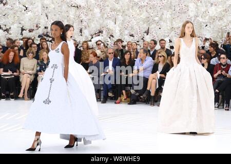 Models display new creations by Christian Dior at its Fall/Winter 2014 Haute Couture fashion show in Paris, France, 7 July 2014. Stock Photo
