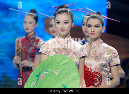Chinese and foreign models display creations of cheongsam, also known ...