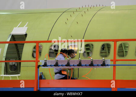 Chinese technicians rivet sections of the fuselage to assemble China¯s ...