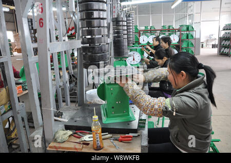 --FILE--Female Chinese workers assemble a car on the assembly line at ...