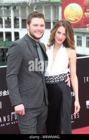 Irish-American actor Jack Reynor, left, and his model fiancee Madeline Mulqueen pose on the red carpet for the world premiere of the movie, Transforme Stock Photo