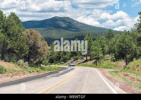 Carson National Forest highway 75 in Penasco, New Mexico with Sangre de Cristo mountains and green pine trees in summer at high road to Taos Stock Photo