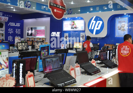 --FILE--Laptop computers are for sale at the counter of HP, Lenovo and Asus at a store in Qingdao city, east Chinas Shandong province, 28 April 2013. Stock Photo