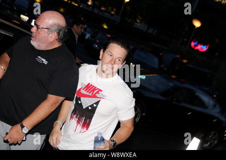 American actor Mark Wahlberg, right, arrives at The Ritz-Carlton Hong Kong hotel in Hong Kong, China, 17 June 2014. Stock Photo