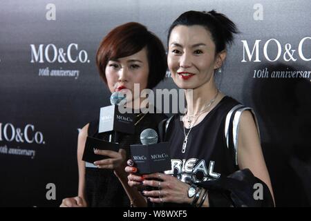 Hong Kong actress Maggie Cheung, right, poses at a fashion event for the 10th anniversary of MO&Co. in Guangzhou city, south Chinas Guangdong province Stock Photo