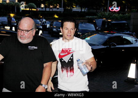 American actor Mark Wahlberg, right, arrives at The Ritz-Carlton Hong Kong hotel in Hong Kong, China, 17 June 2014. Stock Photo