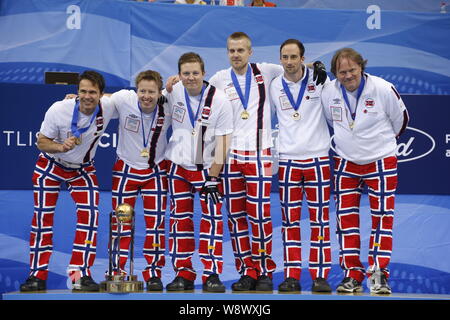 (From left) Curlers Thomas Ulsrud, Torger Nergard, Christoffer Svae, Havard Vad Petersson, Markus Hoiberg and coach Pal Trusen of Norway pose on the p Stock Photo
