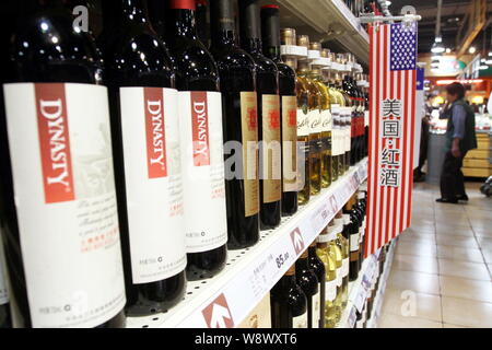 --FILE--Bottles of Dynasty red wine are for sale next to wines imported from the United States at a supermarket in Xuchang city, central Chinas Henan Stock Photo