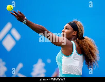 Serena Williams of the United States serves against Alize Cornet of France during the women's singles second round of the 2014 WTA Wuhan Open tennis t Stock Photo