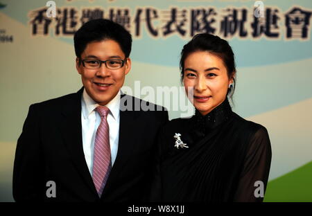 Kenneth Fok Kai-kong, eldest son of Hong Kong tycoon Timothy Fok Tsun-Ting, left, and his wife, Chinese Olympic diving champion Guo Jingjing, smile at Stock Photo