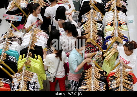 --FILE--Chinese customers shop for clothes at a shopping mall in HuaiAn city, east Chinas Jiangsu province, 22 June 2014.     Chinas retail sales main Stock Photo