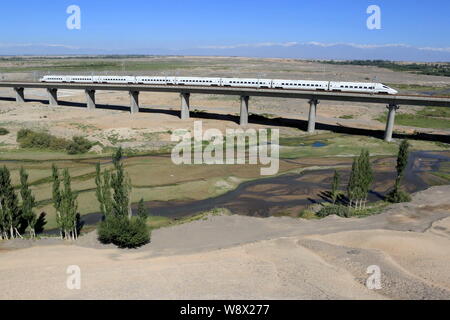 --FILE--A CRH (China Railway High-speed) bullet train passes through the Baiyanggou Bridge on the Lanxing (Lanzhou-Xinjiang) High-speed Railway in Ham Stock Photo