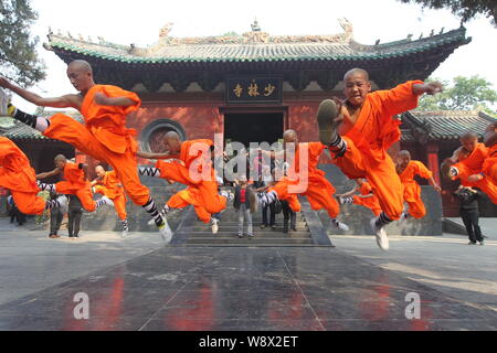 --FILE--Monks perform martial arts during a kung fu presentation at the Shaolin Temple on Mount Songshan in Dengfeng city, central Chinas Henan Provin Stock Photo