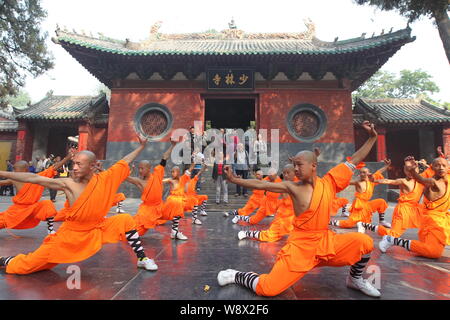 --FILE--Monks perform martial arts during a kung fu presentation at the Shaolin Temple on Mount Songshan in Dengfeng city, central Chinas Henan Provin Stock Photo