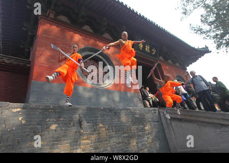 --FILE--Monks perform martial arts during a kung fu presentation at the Shaolin Temple on Mount Songshan in Dengfeng city, central Chinas Henan Provin Stock Photo