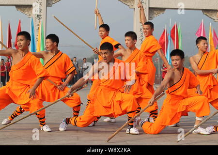 --FILE--Monks perform martial arts during a kung fu presentation at the Shaolin Temple on Mount Songshan in Dengfeng city, central Chinas Henan Provin Stock Photo