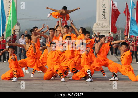 --FILE--Monks perform martial arts during a kung fu presentation at the Shaolin Temple on Mount Songshan in Dengfeng city, central Chinas Henan Provin Stock Photo