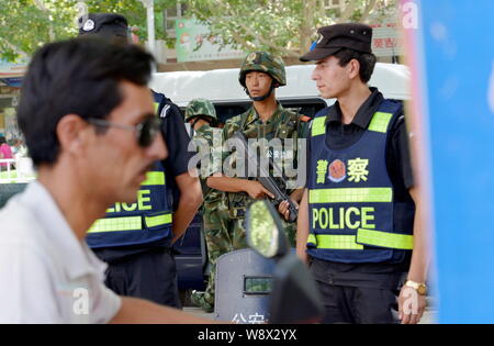 Police and paramilitary officers stand guard around Tiananmen Square ...