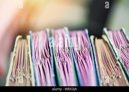 Documents in files placed in the filing cabinet with paper clip / business paper document file sort in a office desk Stock Photo