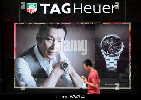 FILE A pedestrian walks past an advertisement for Tag Heuer