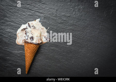 ice cream cone vanilla with chocolate dripping flowing on dark background , Flat lay / ice cream melting scoops popsicle and sweet dessert Stock Photo