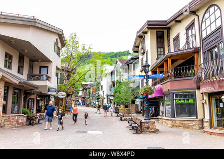 Vail, USA - June 29, 2019: Vacation town in Colorado with people walking by shops and bathrooms on Gore Creek drive Stock Photo