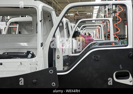 --FILE--Chinese workers assemble trucks on the assembly line at the ...