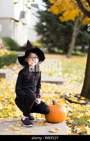 Portrait of little asian girl in witch costume Stock Photo