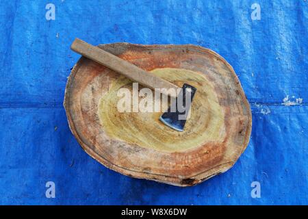 Top angle shot of a butcher axe and a cutting board on blue pad. Stock Photo