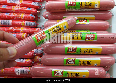 FILE--A customer buys Shineway meat sausage of Shuanghui