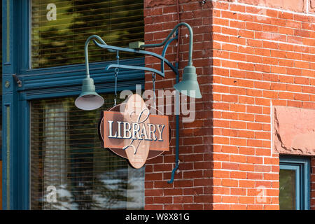 Aspen, USA - June 27, 2019: Town in Colorado with closeup of sign on Main street for library at hotel jerome Stock Photo