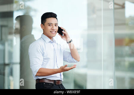 Confident businessman calling on phone Stock Photo