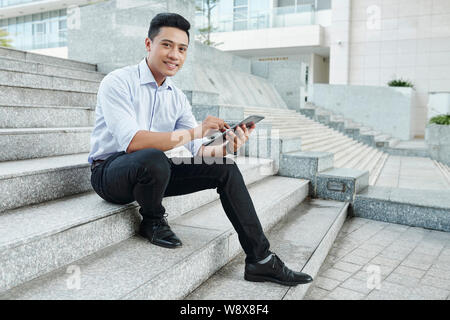 Confident businessman with digital tablet Stock Photo